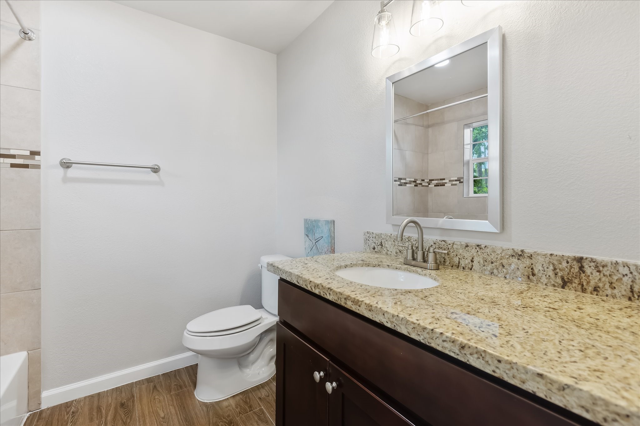 1110 West Patton Street, Unit 4 Houston, TX 77009 - Photo 6 of 8 a bathroom with a granite countertop sink a toilet and a mirror
