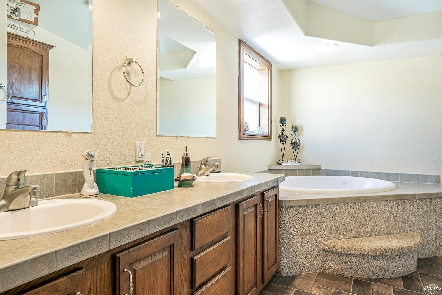 102 Cut Throat Loop Gypsum, CO 81637 - Photo 13 of 25 a bathroom with a sink and a mirror