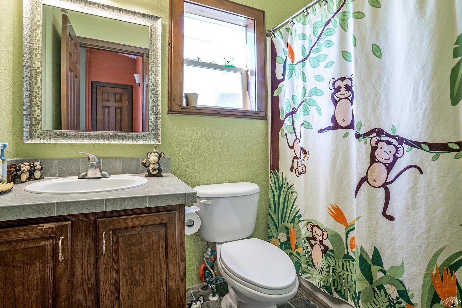 102 Cut Throat Loop Gypsum, CO 81637 - Photo 17 of 25 a bathroom with a granite countertop toilet sink and mirror with window