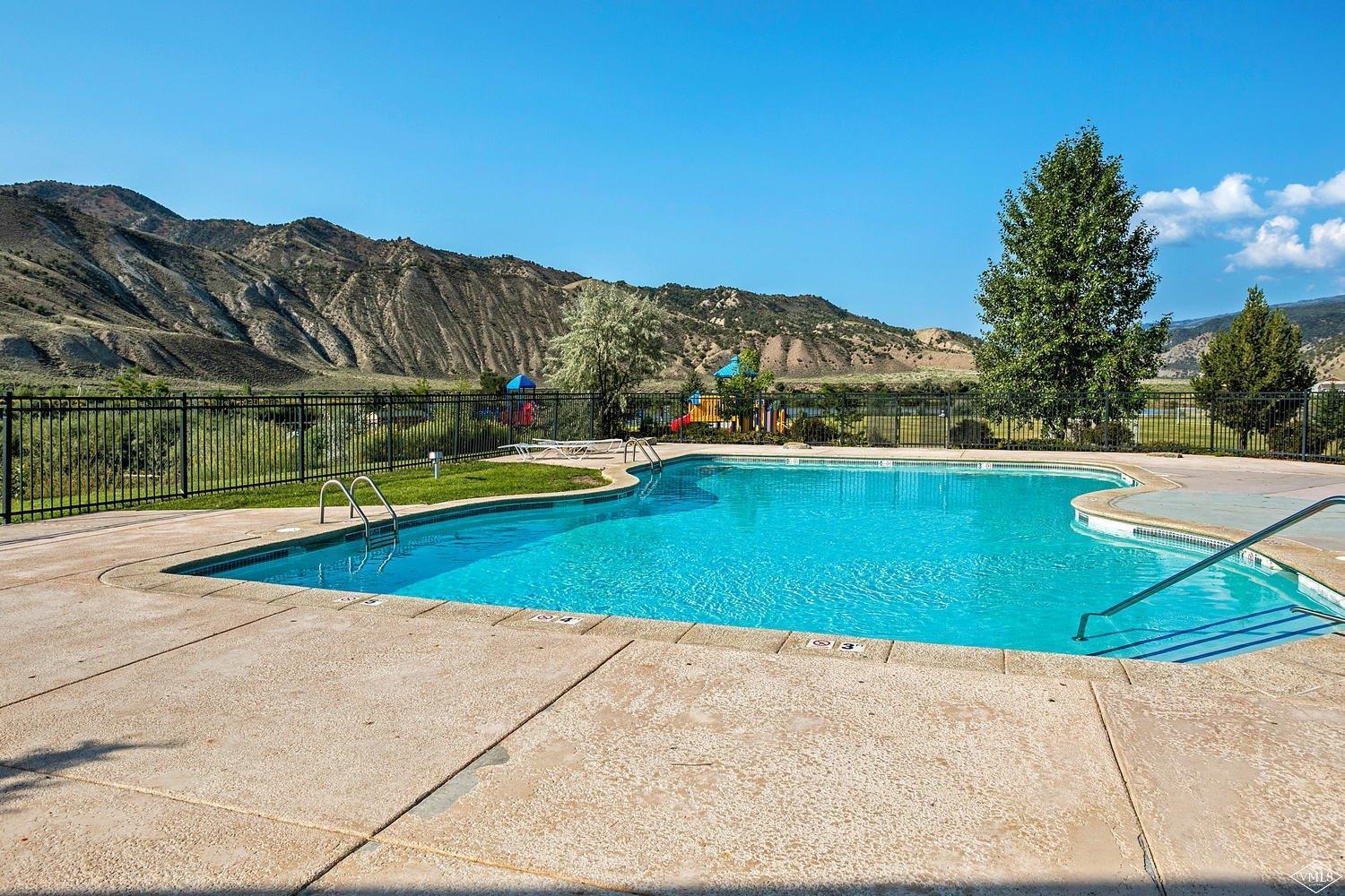 102 Cut Throat Loop Gypsum, CO 81637 - Photo 23 of 25 a view of a swimming pool with a yard and a large tree