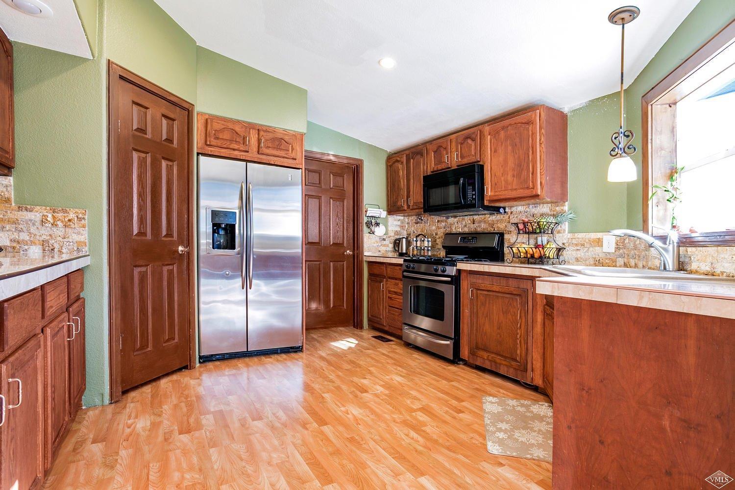 102 Cut Throat Loop Gypsum, CO 81637 - Photo 7 of 25 a kitchen with stainless steel appliances granite countertop a refrigerator and a stove top oven