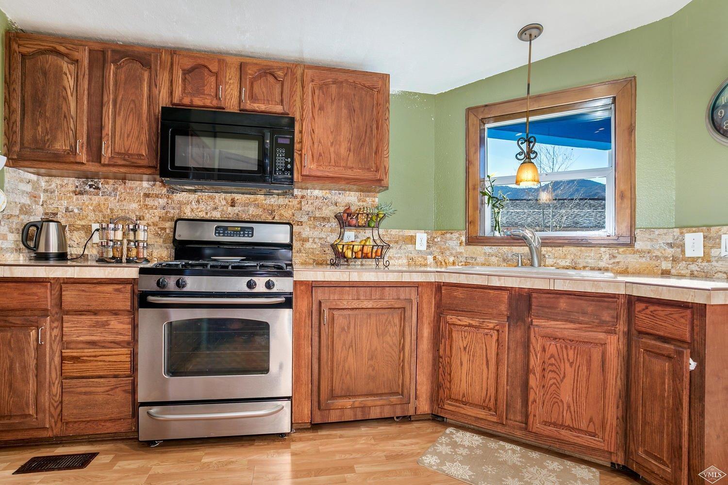 102 Cut Throat Loop Gypsum, CO 81637 - Photo 8 of 25 a kitchen with a stove microwave and sink