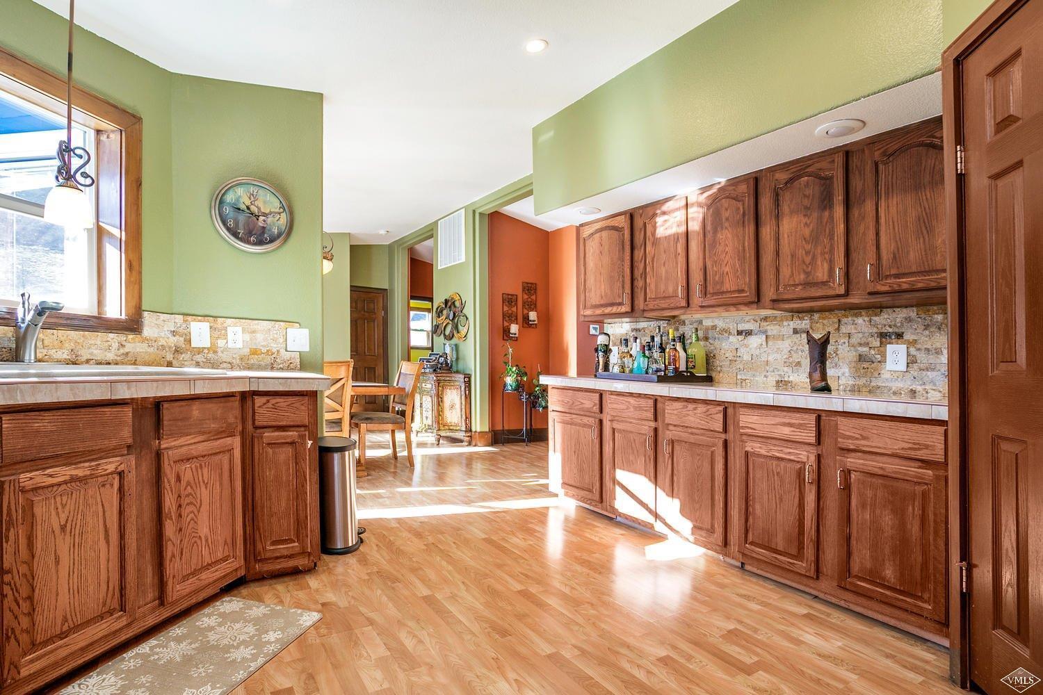 102 Cut Throat Loop Gypsum, CO 81637 - Photo 9 of 25 a kitchen with stainless steel appliances granite countertop wooden cabinets a sink and a stove