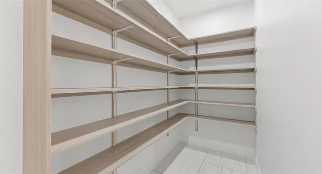 a large white kitchen with kitchen island granite countertop a sink and a stove