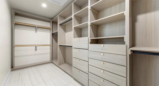 a bathroom with a double vanity sink a mirror and a bathtub