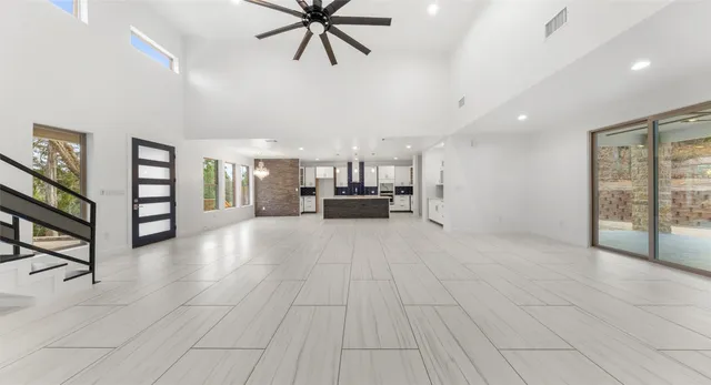 a view of kitchen with windows and refrigerator