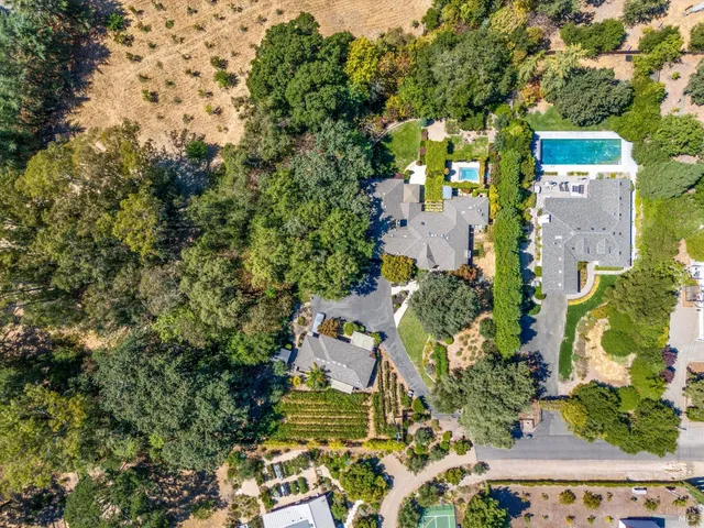 an aerial view of a house with a yard