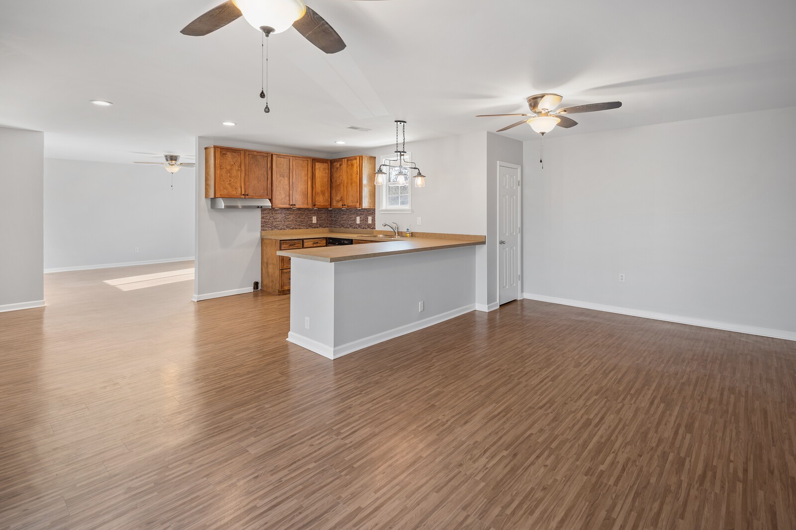 209 Manzano Road Madison, TN 37115 - Photo 3 of 15 a large kitchen with cabinets wooden floor and stainless steel appliances