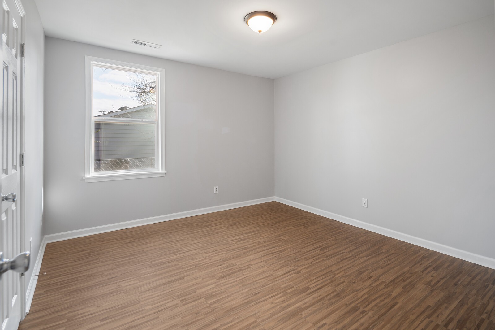 209 Manzano Road Madison, TN 37115 - Photo 6 of 15 a view of an empty room with wooden floor and a window