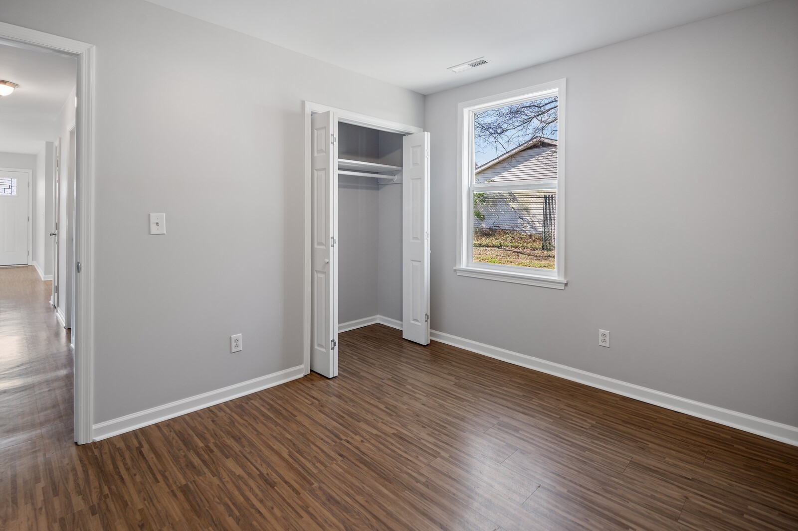 209 Manzano Road Madison, TN 37115 - Photo 8 of 15 an empty room with wooden floor and windows