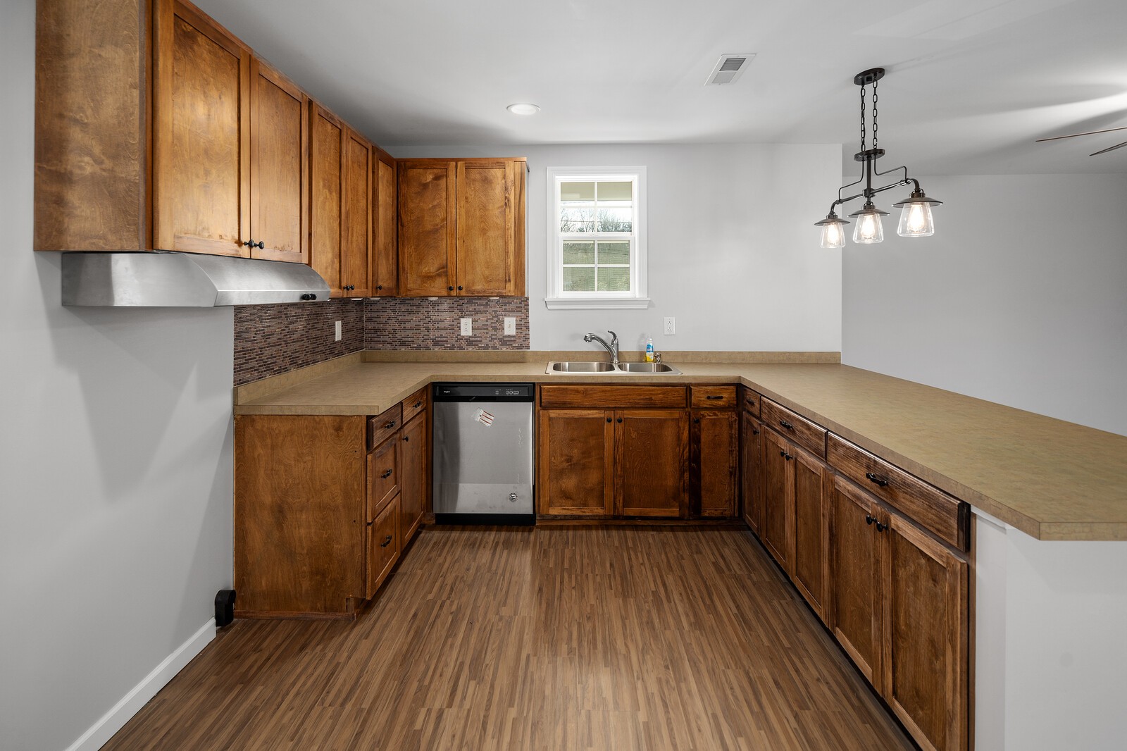 209 Manzano Road Madison, TN 37115 - Photo 9 of 15 a kitchen with stainless steel appliances granite countertop wooden cabinets a sink dishwasher a stove and a refrigerator with wooden floor
