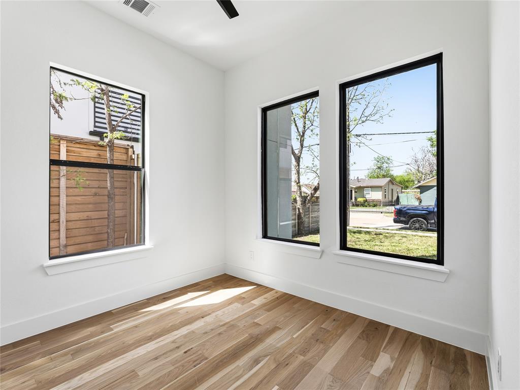 1958 Toronto Street Dallas, TX 75212 - Photo 13 of 32 a view of an empty room with wooden floor and a window