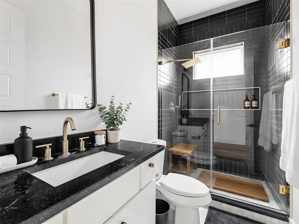 1958 Toronto Street Dallas, TX 75212 - Photo 18 of 32 a bathroom with a sink a toilet and shower