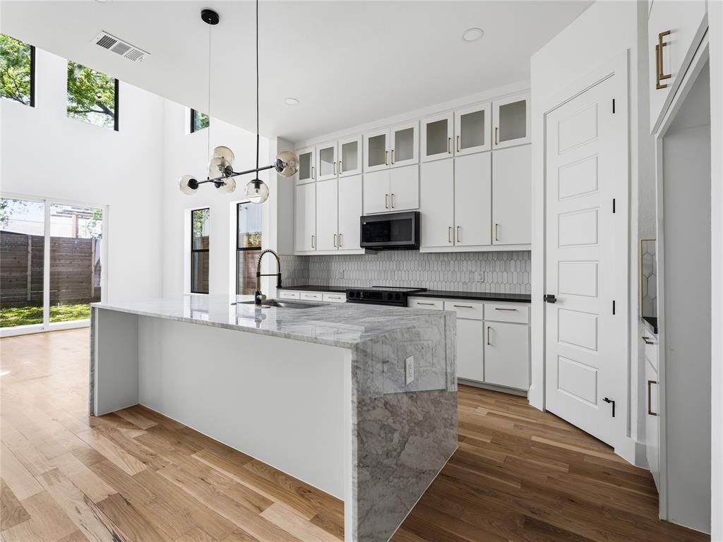 1958 Toronto Street Dallas, TX 75212 - Photo 4 of 32 a kitchen with stainless steel appliances granite countertop a sink and cabinets