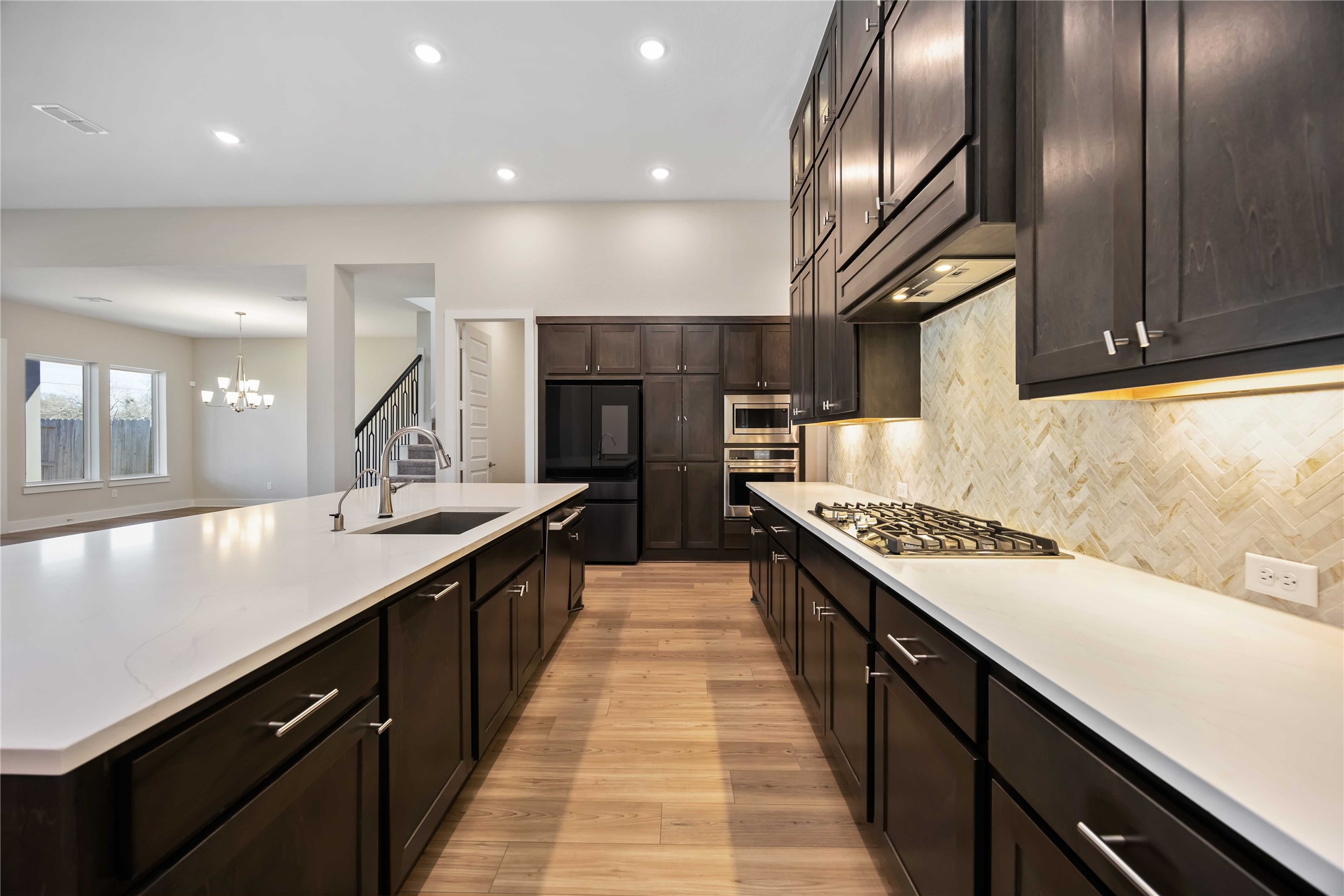 32022 Western Grv Lane Fulshear, TX 77441 - Photo 12 of 49 a large kitchen with stainless steel appliances kitchen island granite countertop a sink and a stove