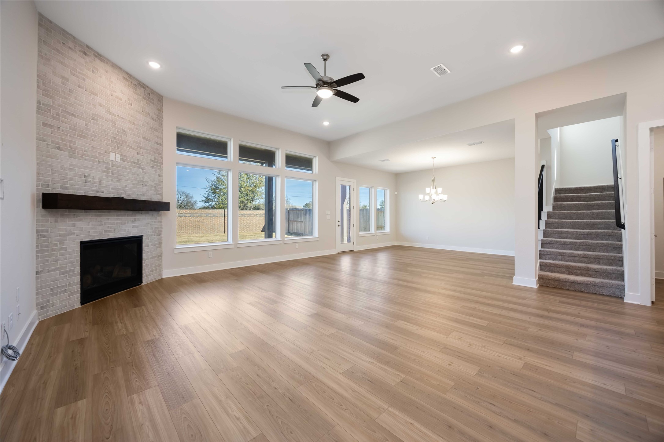 32022 Western Grv Lane Fulshear, TX 77441 - Photo 15 of 49 a view of an empty room with wooden floor fireplace and a window