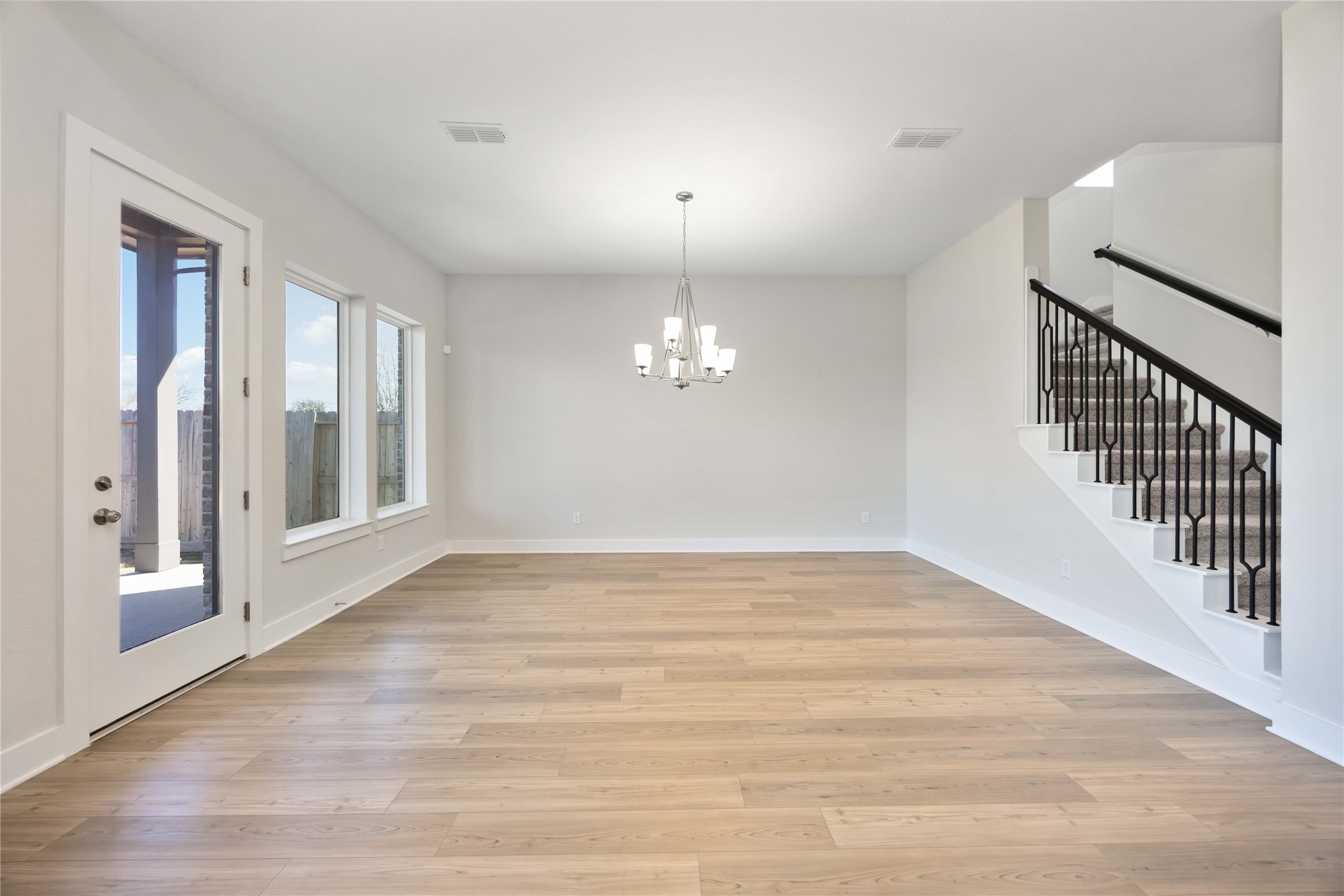 32022 Western Grv Lane Fulshear, TX 77441 - Photo 18 of 49 a view of an empty room with wooden floor and a window