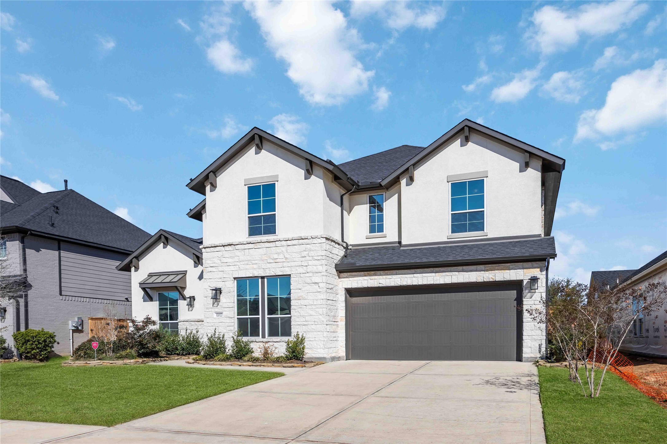 32022 Western Grv Lane Fulshear, TX 77441 - Photo 2 of 49 a front view of a house with a garden and plants