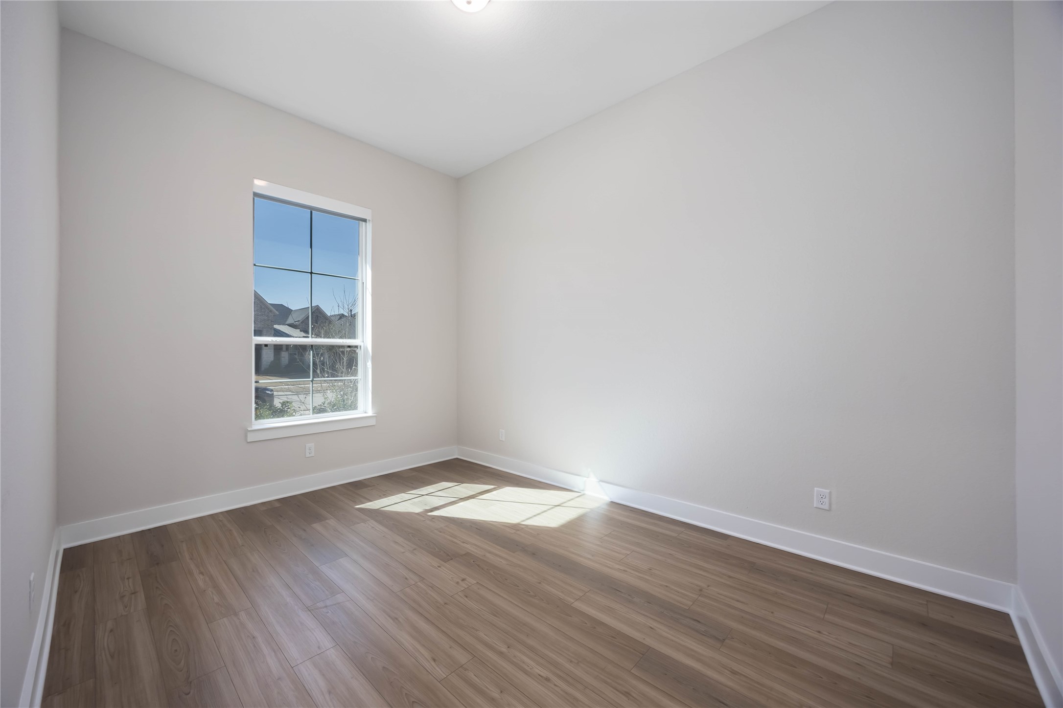 32022 Western Grv Lane Fulshear, TX 77441 - Photo 6 of 49 a view of an empty room with wooden floor and a window