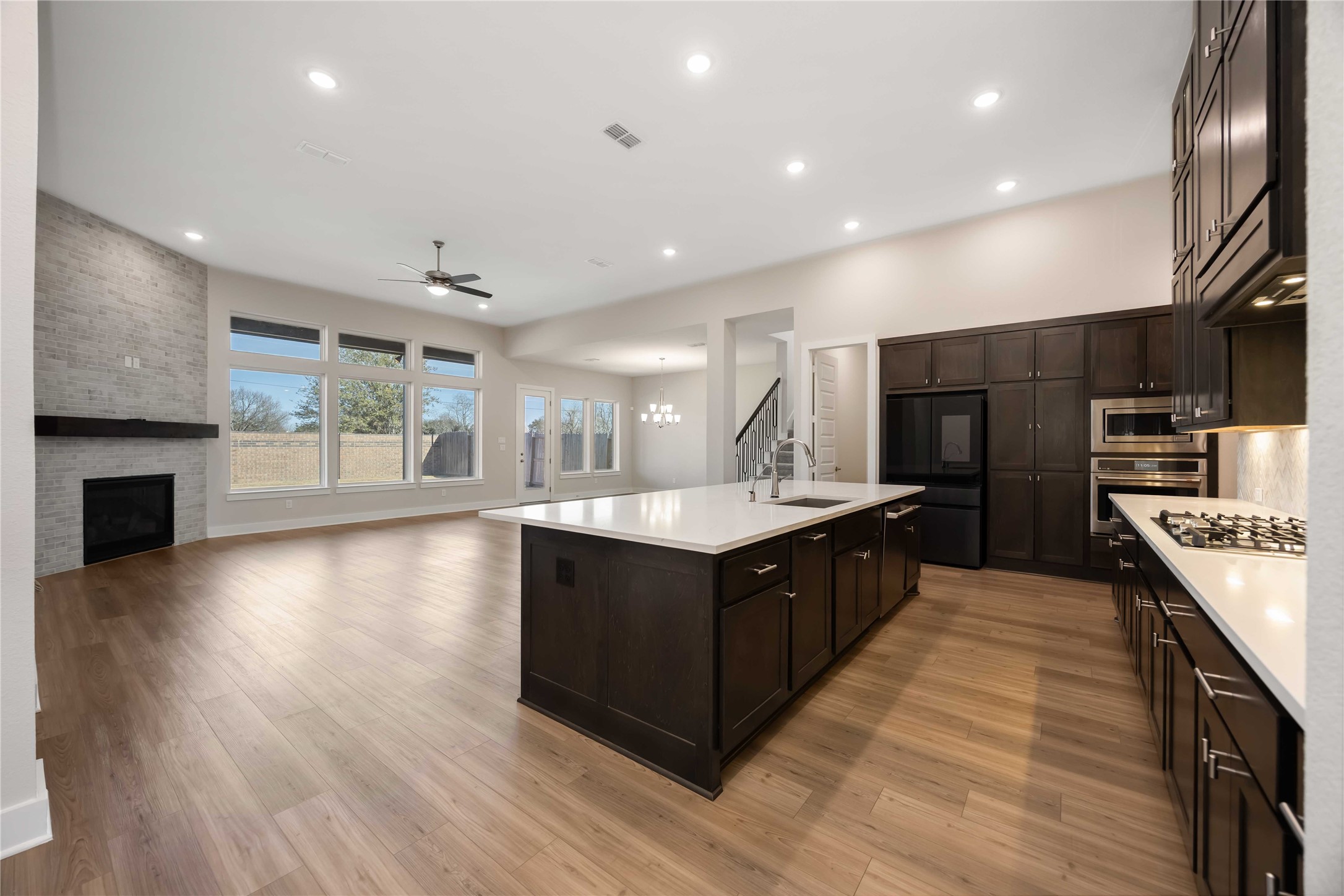 32022 Western Grv Lane Fulshear, TX 77441 - Photo 10 of 49 a large kitchen with stainless steel appliances a large counter top and wooden floor