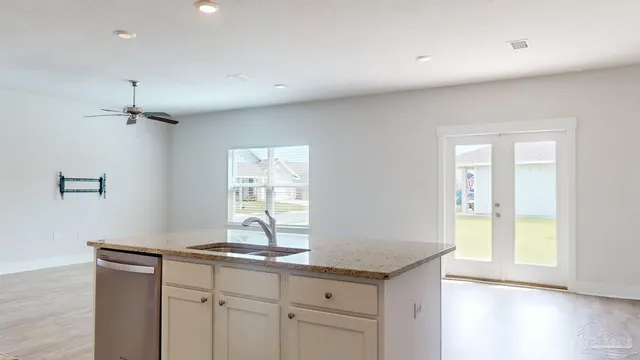 a view of a kitchen with a sink and a window