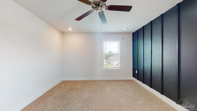 en empty room with windows and fan