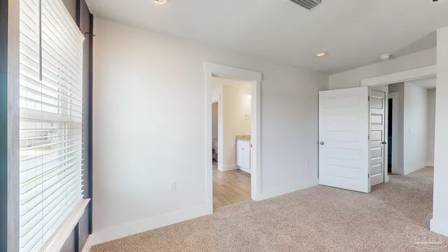 an empty room with windows and closet