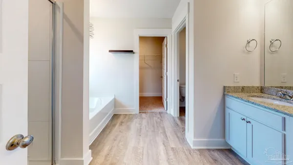 a view of a bathroom from a hallway