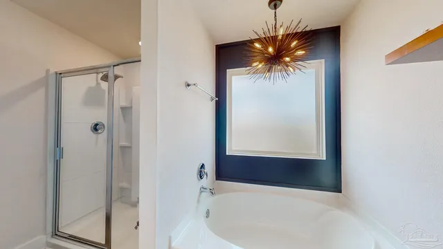 a bathroom with a granite countertop shower a sink and bathtub