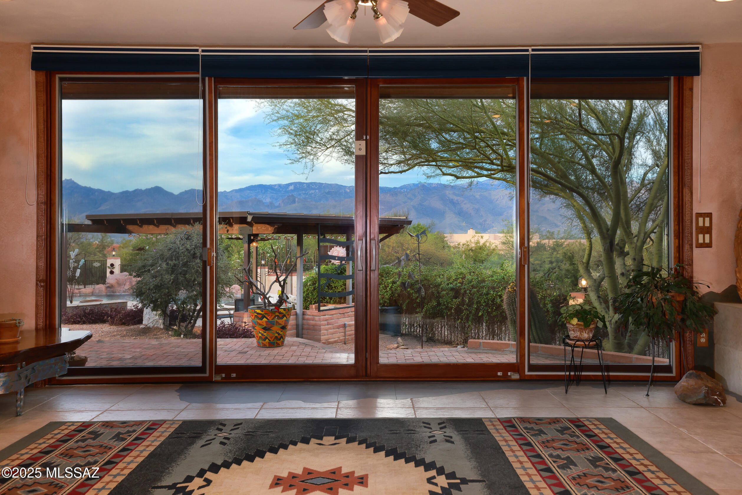 925 North Rancho Del Jefe Loop Tucson, AZ 85748 - Photo 22 of 52 a living room with a floor to ceiling window and a table