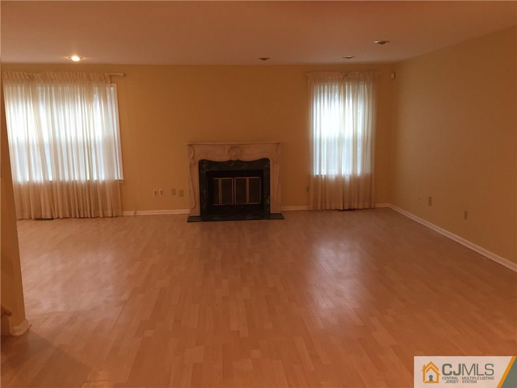 3401 Springbrook Drive Edison, NJ 08820 - Photo 2 of 21 an empty room with windows and fireplace