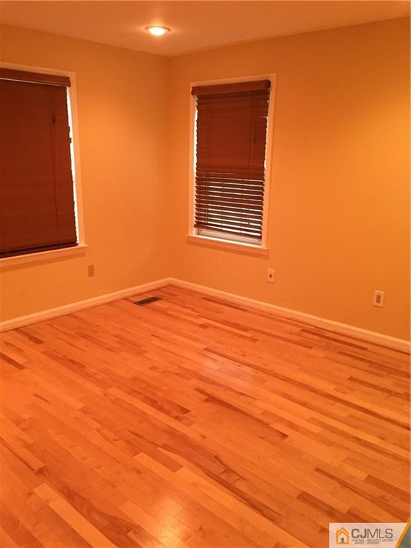 3401 Springbrook Drive Edison, NJ 08820 - Photo 11 of 21 a view of an empty room with wooden floor and a window