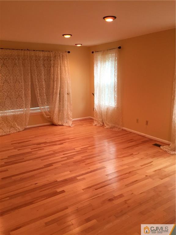3401 Springbrook Drive Edison, NJ 08820 - Photo 13 of 21 an empty room with wooden floor and windows