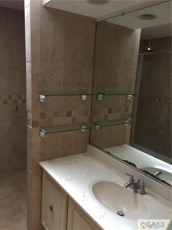 3401 Springbrook Drive Edison, NJ 08820 - Photo 16 of 21 a bathroom with a sink and mirror