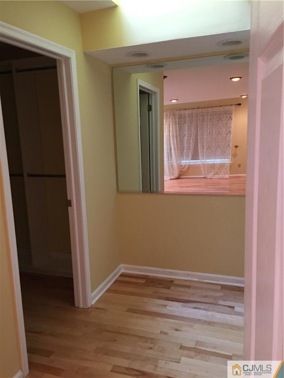 3401 Springbrook Drive Edison, NJ 08820 - Photo 17 of 21 a view of a hallway with wooden floor