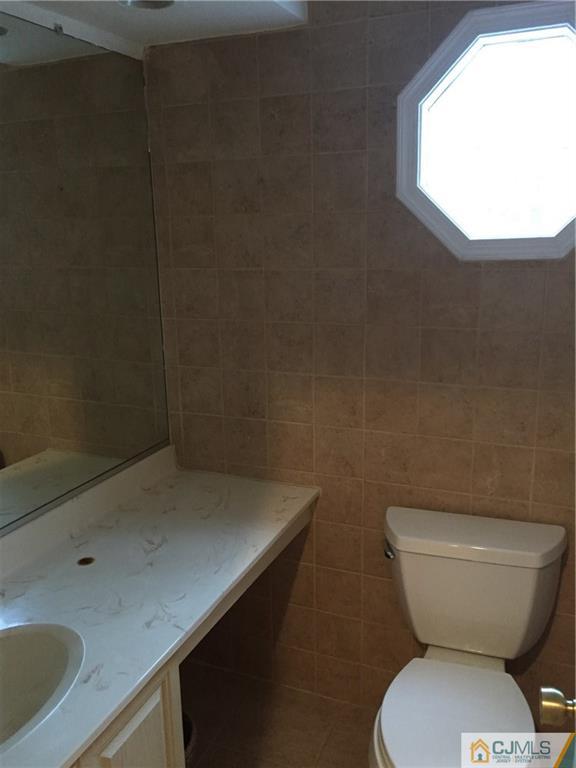 3401 Springbrook Drive Edison, NJ 08820 - Photo 8 of 21 a bathroom with a toilet sink and mirror