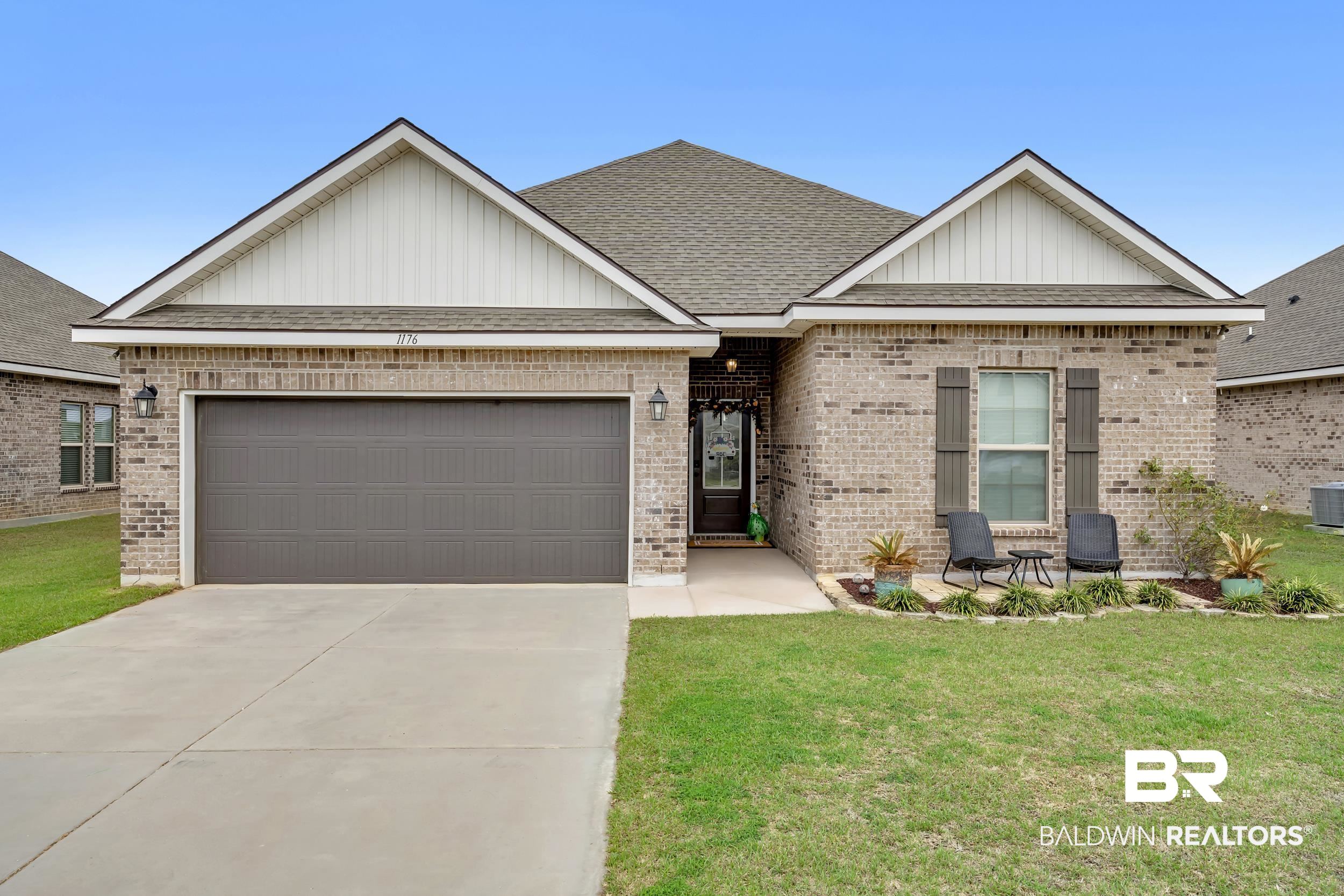 1176 Stella Road Foley, AL 36535 - Photo 1 of 40 Ranch-style house featuring roof with shingles, an attached garage, driveway, a front yard, and board and batten siding