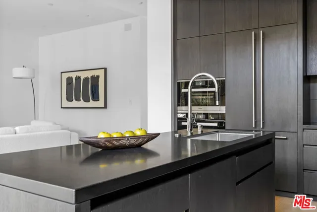 a kitchen with lots of counter top space a stove and a wooden floor