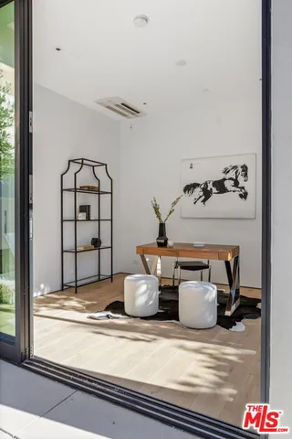 a view of a patio with table and chairs and potted plants