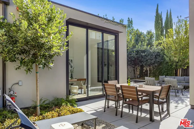 a swimming pool with outdoor seating and yard