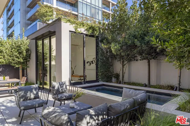 a view of a house with pool and sitting area