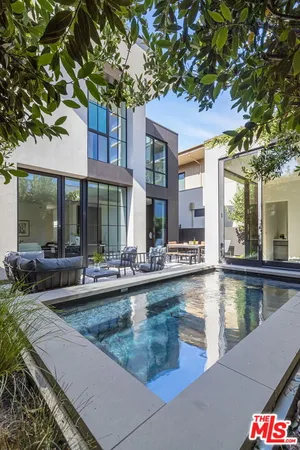 a view of a swimming pool with outdoor seating