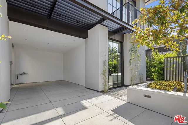 a view of a white house next to a yard