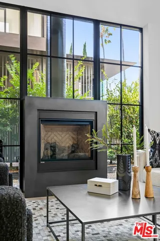 a living room with furniture and a floor to ceiling window