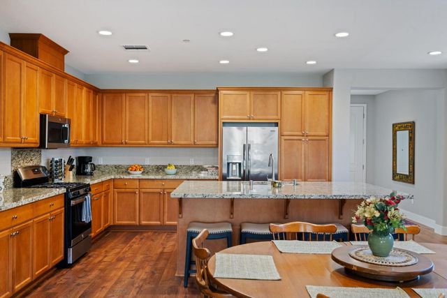 an open kitchen with dining table and chairs