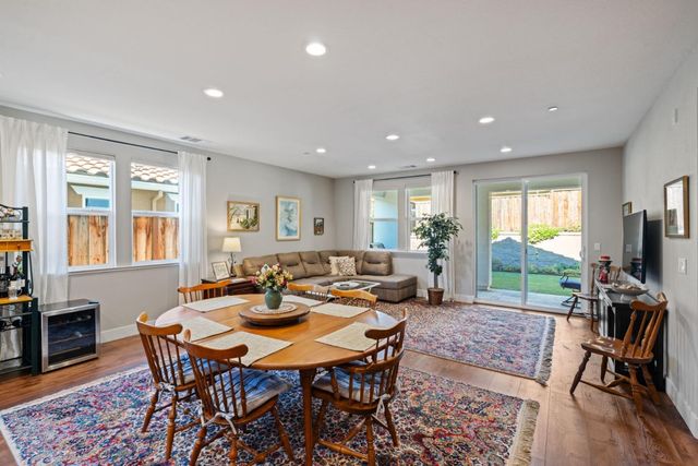 a living room with furniture a window and a flat screen tv