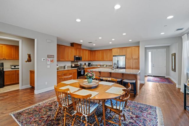 a kitchen with stainless steel appliances wooden cabinets and a refrigerator