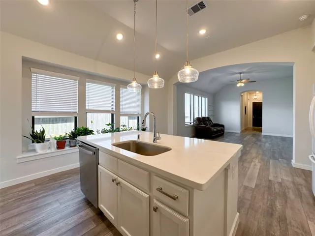 a large white kitchen with a large island