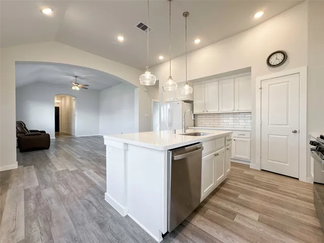 a kitchen with a stove a sink and a refrigerator