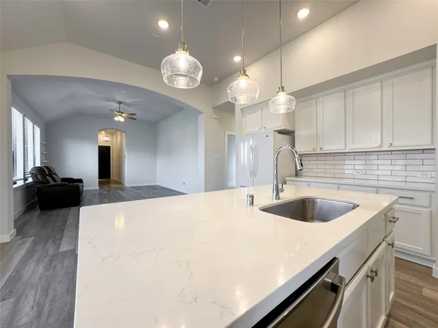 a kitchen with a sink and chandelier
